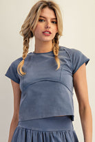 Front view of mineral washed cropped tee showing curved seam detailing and raw edge finish