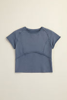 Close-up of curved seam detailing with raw edges on mineral washed tee