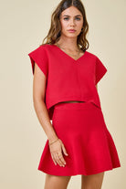 red knit v neck sweater cap sleeve with swing skirt worn as a set front view