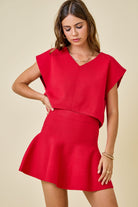red knit v neck sweater cap sleeve with swing skirt worn as a set top and skirt