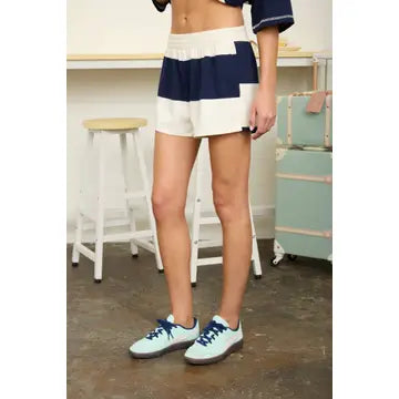 Sporty rugby stripe matching set featuring a relaxed oversized fit, soft knit fabric, and coordinating shorts. Chic women's athleisure outfit perfect for game days, weekend outings, and laid-back fashion.