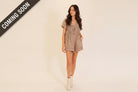 Casual boho utility romper with vintage washed finish, short sleeves, deep V neckline, and front tie from Thread Bar Boutique