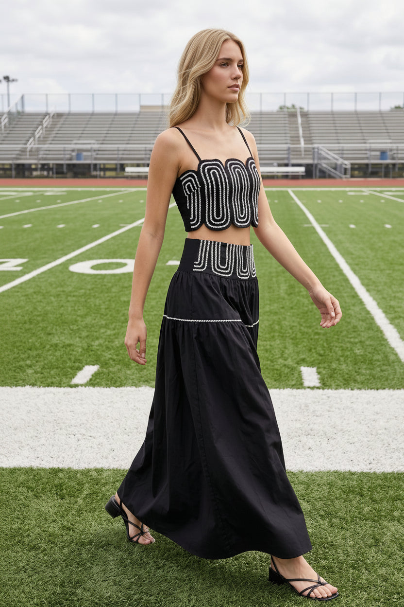 Women's boutique black matching skirt set with feminine lace trim, fitted crop top, smocked back, and flowing lined maxi skirt. Lightweight and comfortable two-piece outfit for SEC game day, tailgates, concerts, vacations, parties, and stylish everyday wear.
