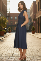 Casual women's cotton denim midi dress with relaxed drop shoulder fit, fitted smocked waist, and below-knee length