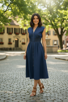 Women's casual denim midi dress styled for summer with a relaxed drop shoulder fit, smocked waist, and versatile everyday design