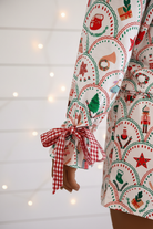 Cozy Christmas pajama set for women with scallop print and plaid details, long sleeve button-up top, ribbon waist, and full-length pants