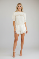 Women's cream cropped knit sweater with rhinestone Martini graphic, cocktail glass embellishment, and relaxed fit from Thread Bar Boutique