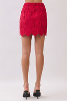 Trendy women’s floral lace outfit with sleeveless crop top and matching scalloped mini skirt for a coordinated two-piece look