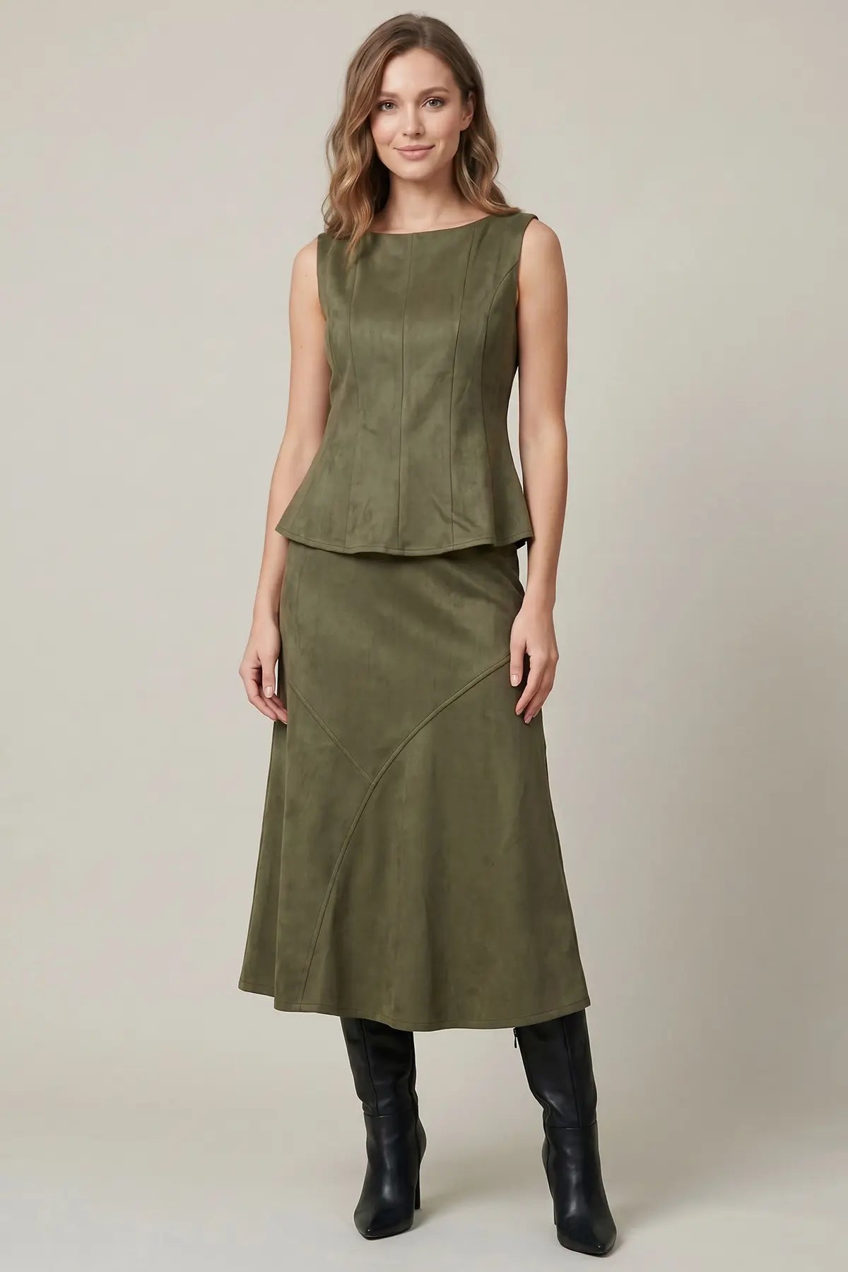 Women's structured suede-feel peplum top styled for a night out with a sophisticated fitted silhouette and boat neckline
