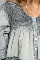 Feminine long sleeve blouse with lace detail bodice, tiered hem, button front closure, and soft washed cotton fabric. Stylish women's top perfect for boutique fashion lovers, everyday wear, teacher outfits, and elevated casual style.