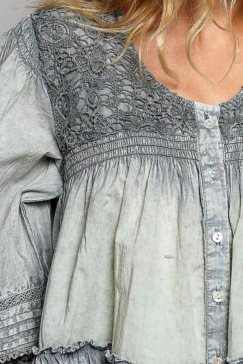 Feminine long sleeve blouse with lace detail bodice, tiered hem, button front closure, and soft washed cotton fabric. Stylish women's top perfect for boutique fashion lovers, everyday wear, teacher outfits, and elevated casual style.
