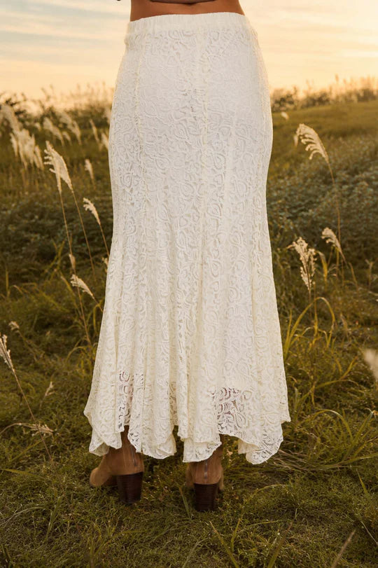 Cream lace godet midi skirt from Thread Bar Boutique featuring an elastic waistband, fully lined construction, and elegant movement. Timeless boutique skirt perfect for weddings, brunch dates, and dressy casual outfits.