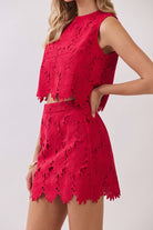 Floral lace crop top paired with matching high-rise mini skirt featuring intricate cutout detailing and scalloped hems
