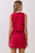 Women’s floral lace two-piece set featuring a sleeveless crop top and matching high-rise mini skirt with scalloped hems