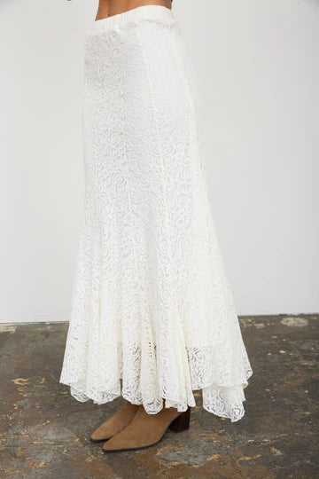 Women's flowy cream lace midi skirt from Thread Bar Boutique with soft lace detailing, a comfortable elastic waist, and feminine godet panels. Chic boutique clothing for special occasions and everyday elegance.