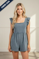 Women’s denim romper featuring a square neckline, ruffle shoulder details, short sleeves, and a cinched tie-back waist, perfect for game day, tailgates, stadium outfits, and weekend wear.