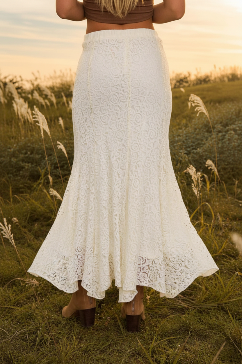 Women's cream lace midi skirt from Thread Bar Boutique with a flattering high-waist fit, delicate lace overlay, and flowing godet hem. Romantic boutique fashion piece ideal for spring, summer, and transitional styling.