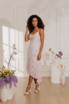 Model wearing the Midnight Garden floral chiffon maxi dress with ruffles and a smocked back, ideal for summer wedding guest outfits and graduation pictures.