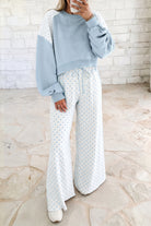 Light blue women’s matching set with a cropped crew neck sweatshirt, long balloon sleeves, ribbed cuffs, and relaxed wide-leg pants with an elastic drawstring waist.