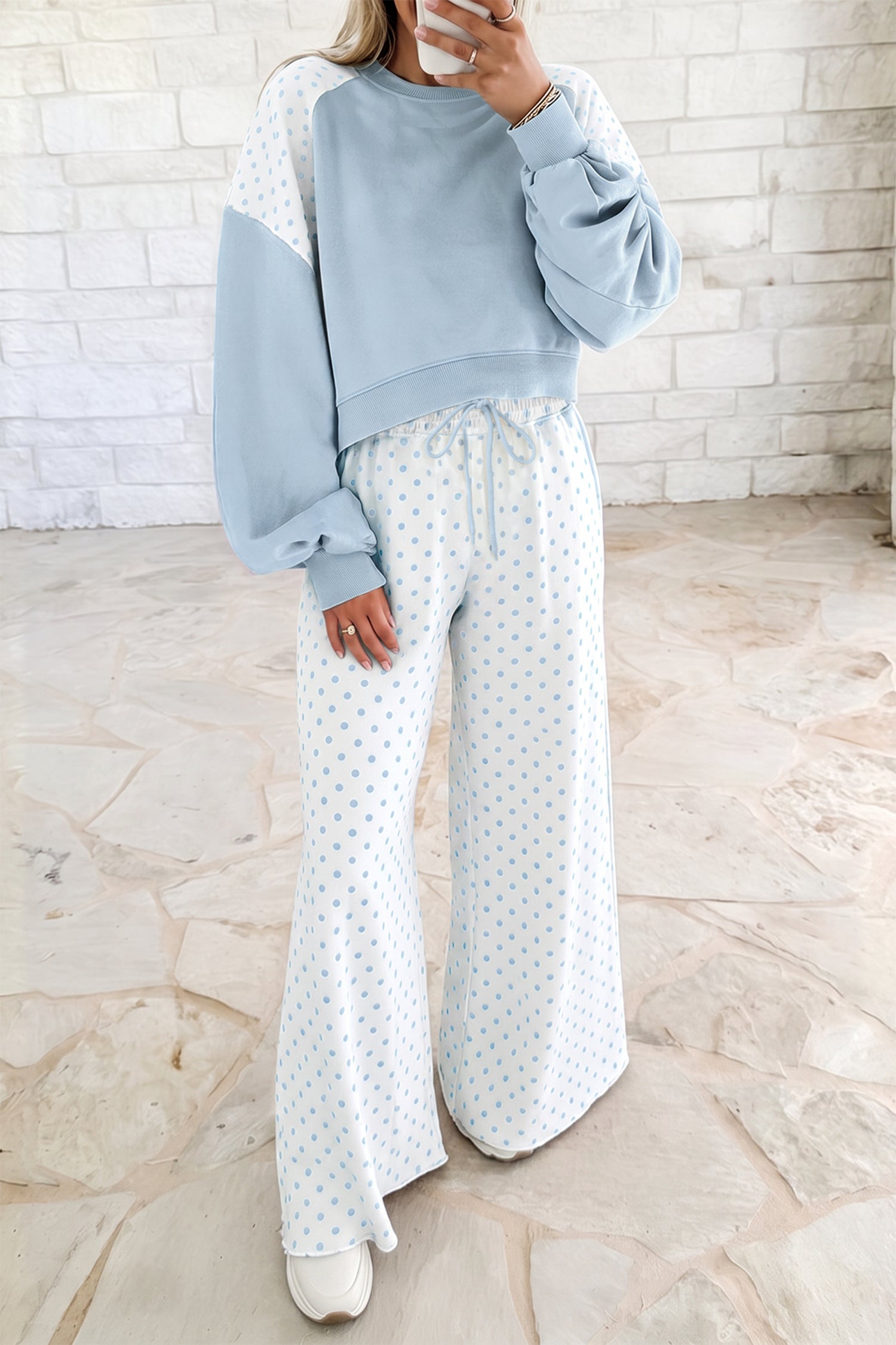 Light blue women’s matching set with a cropped crew neck sweatshirt, long balloon sleeves, ribbed cuffs, and relaxed wide-leg pants with an elastic drawstring waist.