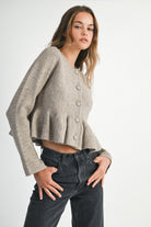 Soft taupe button-down knit peplum jacket with defined waist, cozy and elegant everyday layering piece.