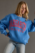 Woman wearing a vintage blue margarita weather graphic sweatshirt 