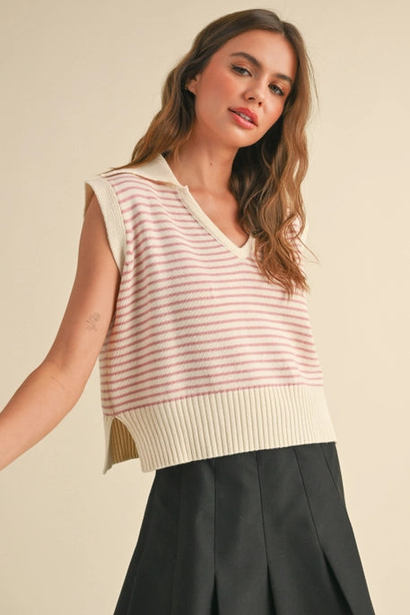 A model wearing a  pink striped sleeveless knit vest with a V-neckline and ribbed hem