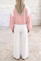 Trendy pink polka dot matching set with a cropped long sleeve top and relaxed wide-leg pants, creating an effortless outfit for brunch, travel, casual days, or lounging.