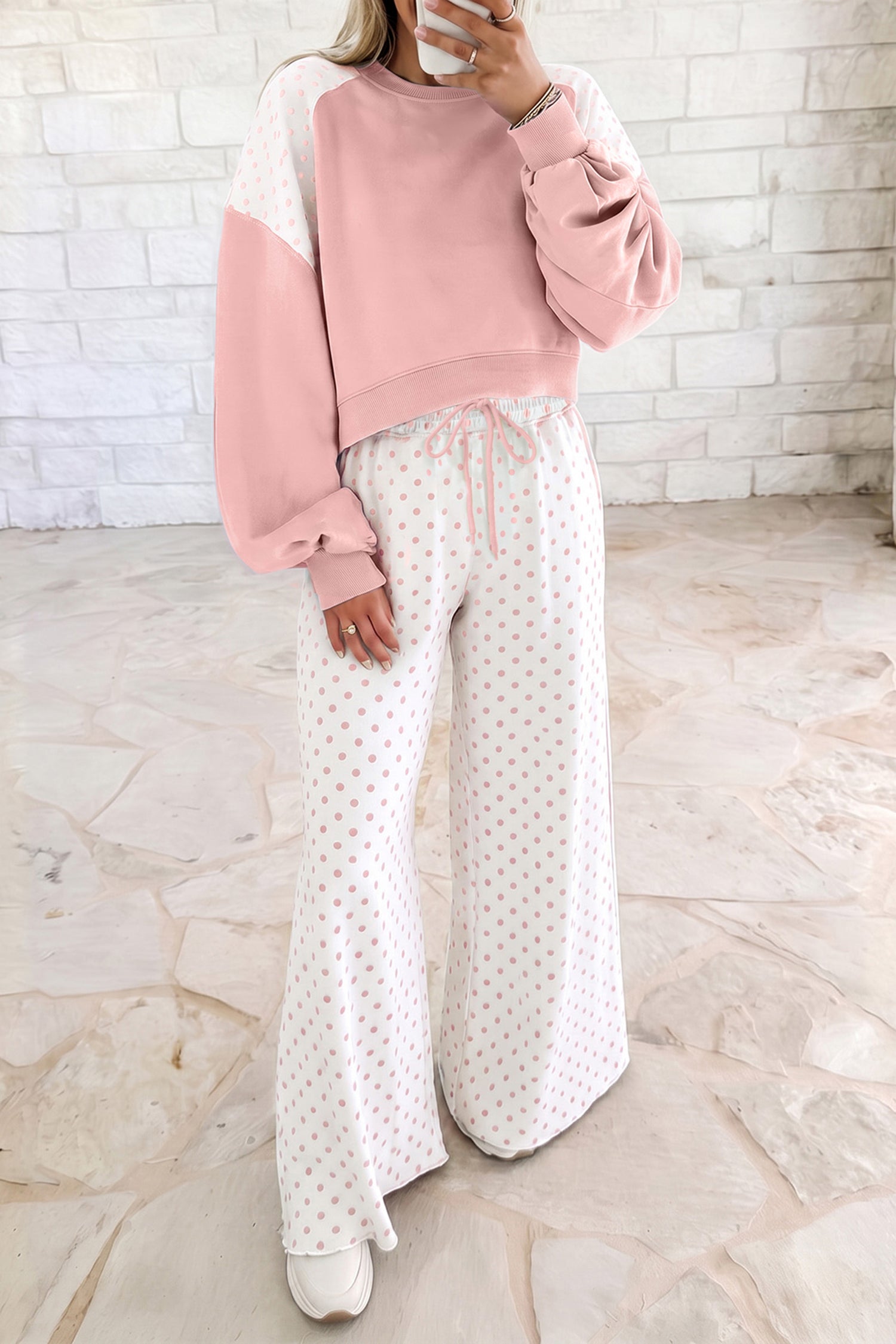 Pink women’s matching set with a cropped crew neck sweatshirt, long balloon sleeves, ribbed cuffs, and coordinating wide-leg pants with an elastic drawstring waist