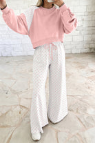 Women’s pink lounge set with a cropped sweatshirt and matching wide-leg drawstring pants, featuring a playful colorblock polka dot print and comfortable relaxed fit.