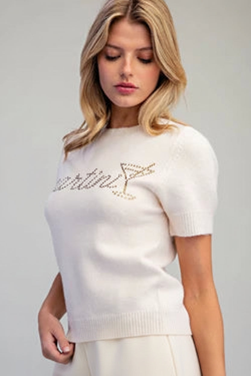 Trendy cream cropped sweater with sparkling rhinestone cocktail lettering and martini glass design, perfect for a fun night out from Thread Bar Boutique