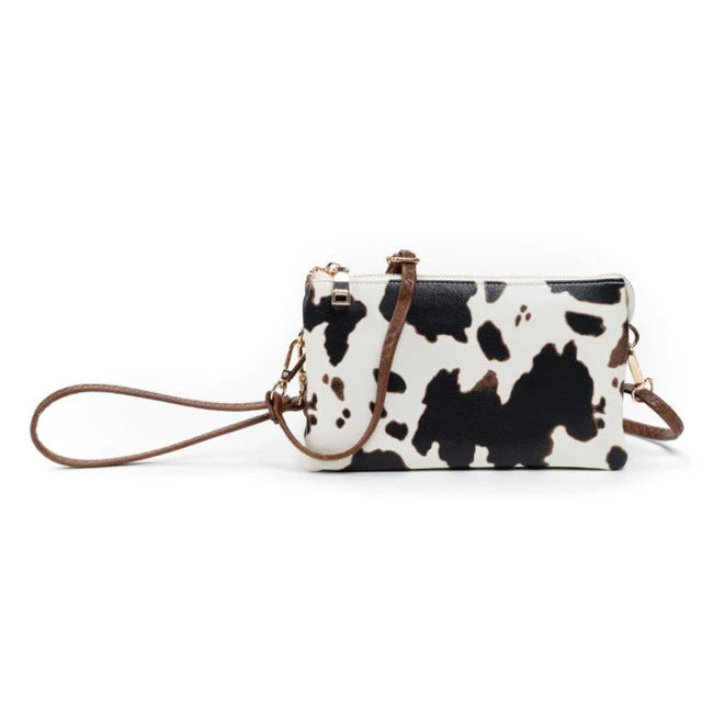 Jen & Co Riley convertible crossbody wristlet with three compartments, six card slots, and secure zip closure in cow print