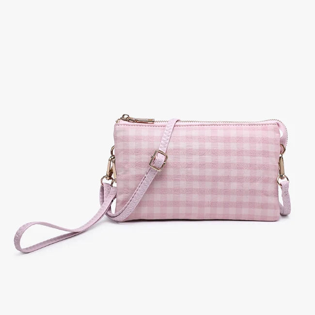 Multi-functional crossbody purse that converts to a wristlet, featuring organized compartments and built-in card slots