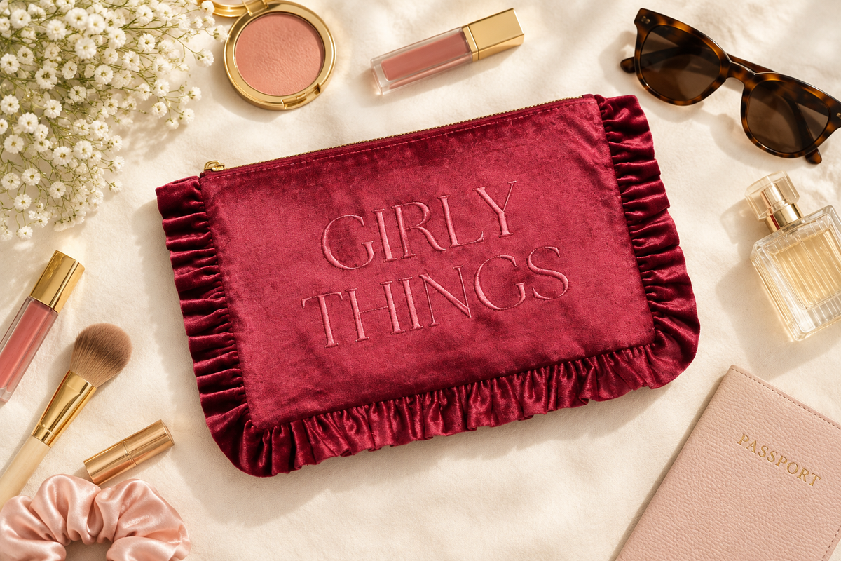 Thread Bar Boutique pink velvet toiletry bag with embroidered design, feminine ruffle edge, zip-top closure, and roomy interior for skincare, makeup, hair accessories, and travel essentials