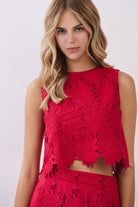 Sleeveless floral lace crop top with round neckline, boxy silhouette, and back keyhole button closure