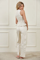 Structured woven peplum top featuring a fitted waist and flared peplum hem with feminine volume and tailored construction