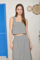 Black textured crop top with matching flowy midi skirt