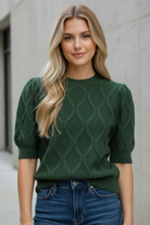 Pine green cable knit sweater with short puff sleeves, ribbed crew neckline, cuffs, and hem from Thread Bar Boutique