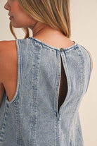 Women's light wash denim two piece set featuring a sleeveless fit and flare tunic top with matching high-rise shorts, front view.
