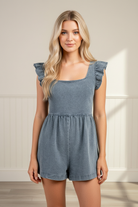 Women’s short sleeve denim romper with a square neckline, ruffle shoulder detailing, and a waist-cinching tie-back design, creating a feminine silhouette for game days, brunch, and casual outings.