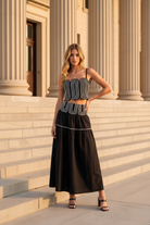 Black lace trim maxi skirt set with a fitted crop top, smocked back panel, and flowing lined skirt for a flattering feminine fit. Popular boutique matching set perfect for football game day, tailgates, summer outings, vacations, celebrations, and dressy casual occasions.
