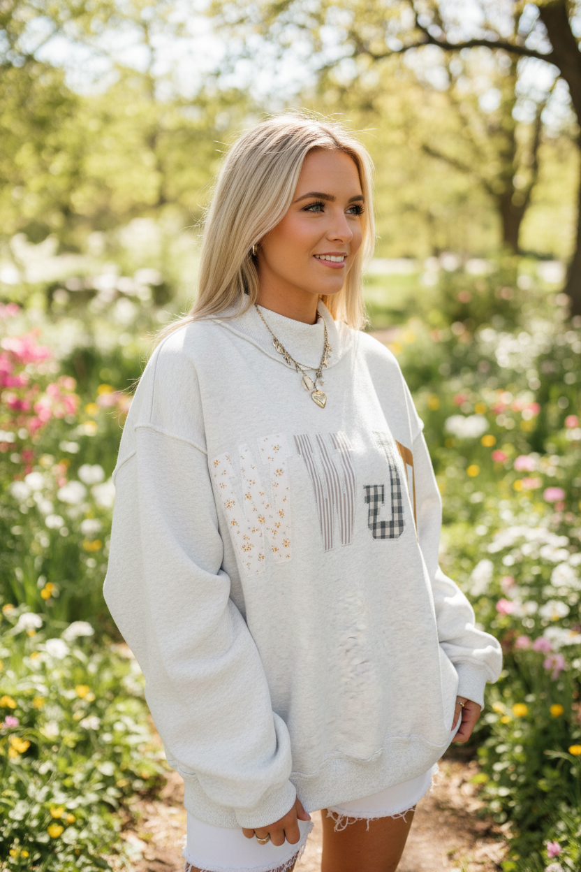 Women's WWJD Christian sweatshirt styled for a casual everyday outfit, featuring a relaxed mock neck silhouette, long sleeves, embroidered graphic detail, and comfortable midweight fabric.