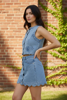 Women's washed denim vest and skirt set from Thread Bar Boutique with button-front vest, scalloped edges, and a flattering high-waist mini skirt. Perfect boutique fashion for summer events and casual chic outfits.