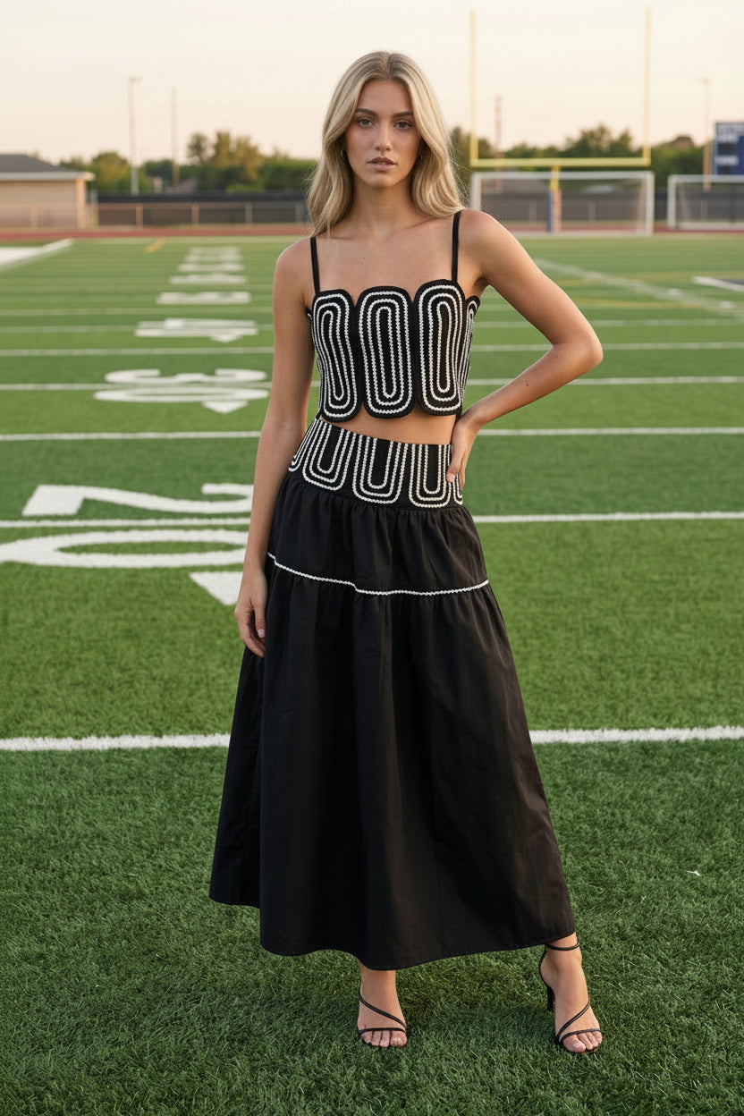 Fashion-forward black coordinated two-piece set featuring a fitted lace trim top and elegant flowy maxi skirt with invisible zipper closure. Lightweight lined boutique outfit ideal for game day fashion, brunch dates, country concerts, vacations, and seasonal events.
