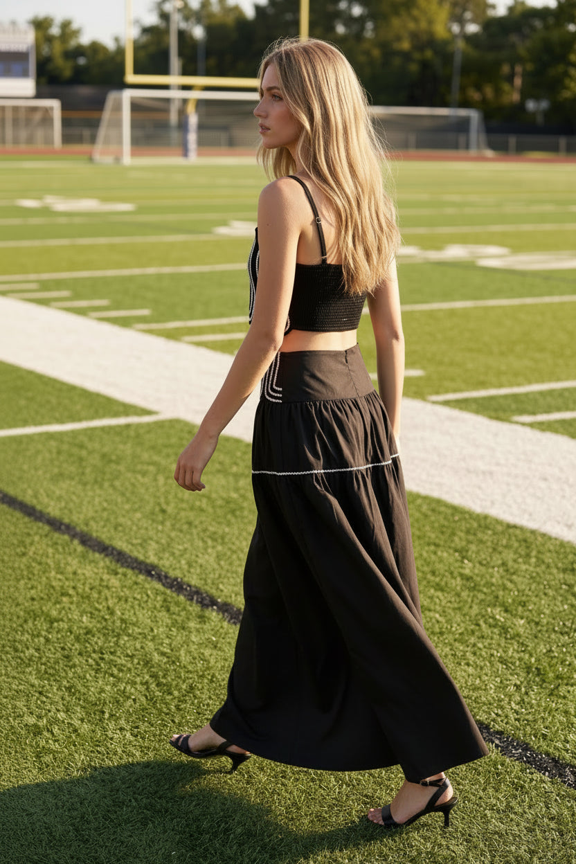 Women's black two-piece matching set with a fitted lace trim crop top and flowy maxi skirt. Fully lined lightweight fabric with a comfortable smocked back and elegant silhouette. Perfect boutique outfit for game day, tailgates, date nights, resort vacations, and summer events.
