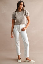 Women's button front sweater styled as a layering piece over a fitted top, featuring short puff sleeves, relaxed fit, crew neckline, and versatile knit construction.