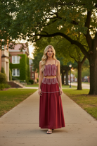 Women's crimson and white game day skirt set featuring a fitted top, flowing skirt, delicate lace trim, and feminine two-piece design for football games, tailgates, and events.