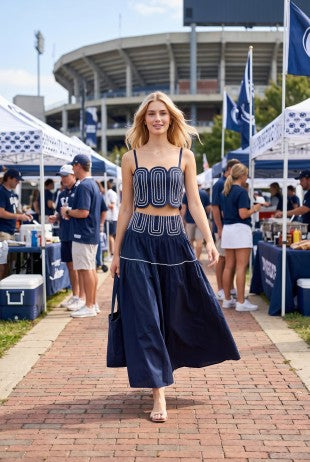 Women's navy and white lace trim skirt with a lightweight fully lined design and flowing silhouette, paired with a fitted matching top for a stylish game day outfit.