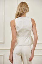 Women’s sleeveless high neck peplum top paired with matching barrel leg pants for a trendy structured two-piece outfit