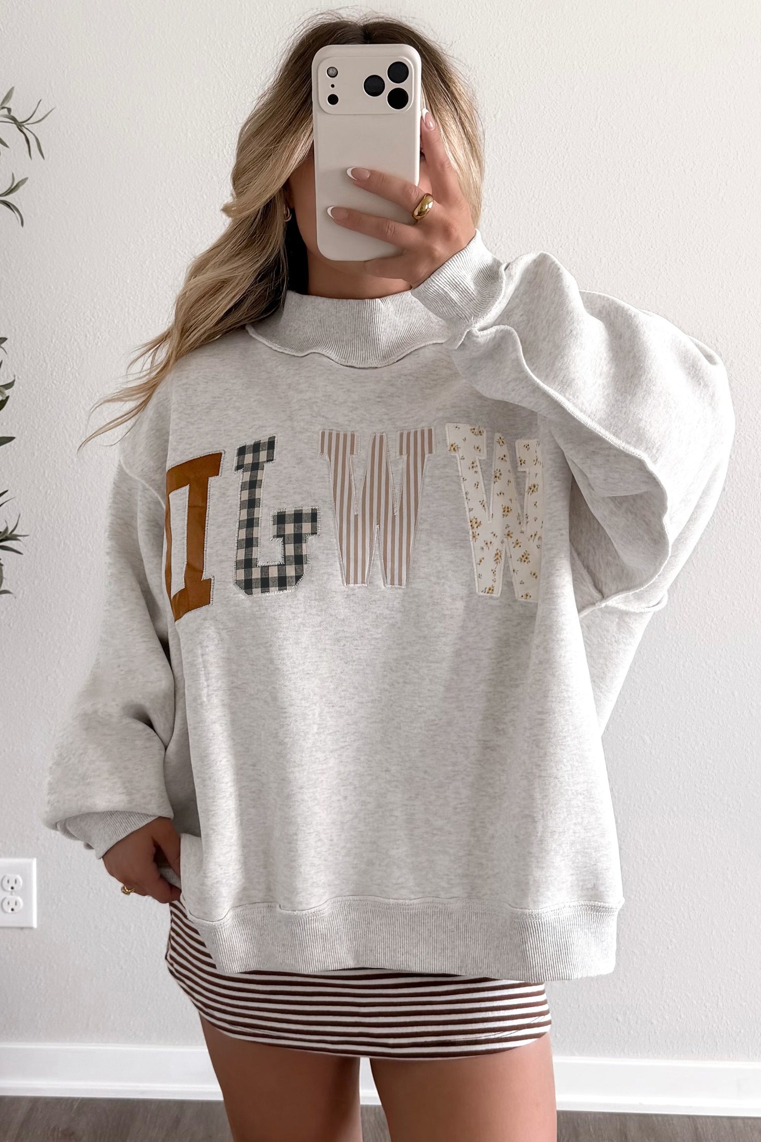 Women's WWJD mock neck sweatshirt with long sleeves, ribbed cuffs, relaxed shift silhouette, and soft midweight fabric for comfortable everyday Christian-inspired style.